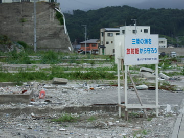 Four months are the tsunami and earthquake 2011, the sign reads 